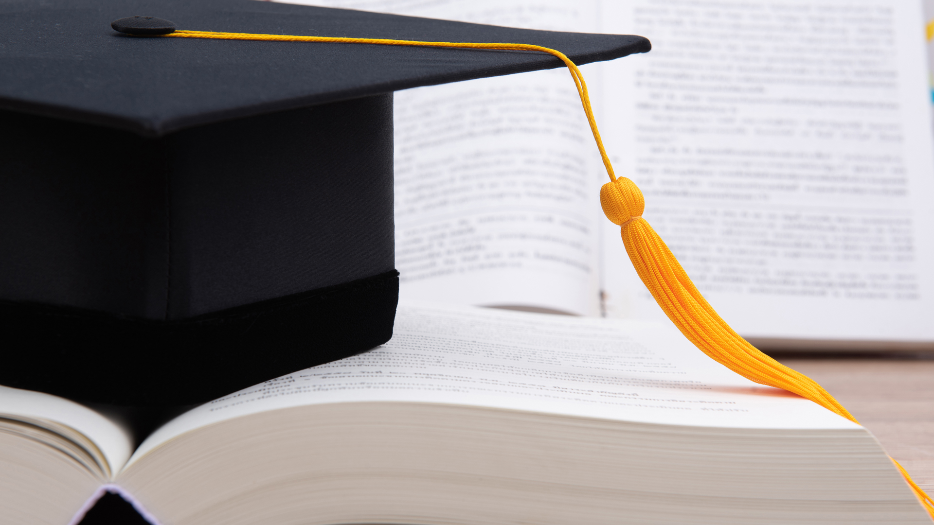 Graduation cap with books