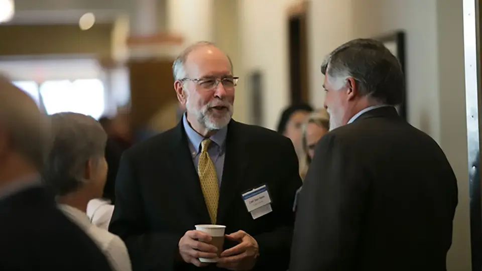 The Heldrich Center's Carl Van Horn talks with attendees at the Investing in America’s Workforce Conference.